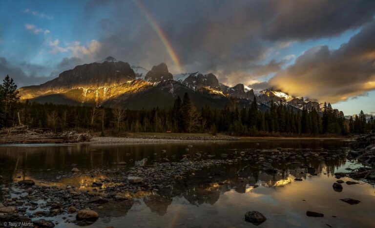 The Canadian Rockies with a Rainbow hitting the peaks of the mountains