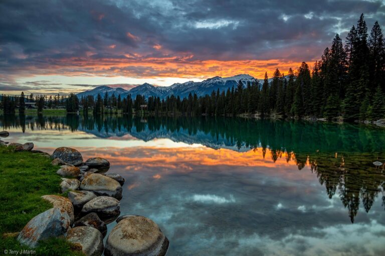 Jasper National Park at Sunrise where the reflection of the landscape can be seen in the water