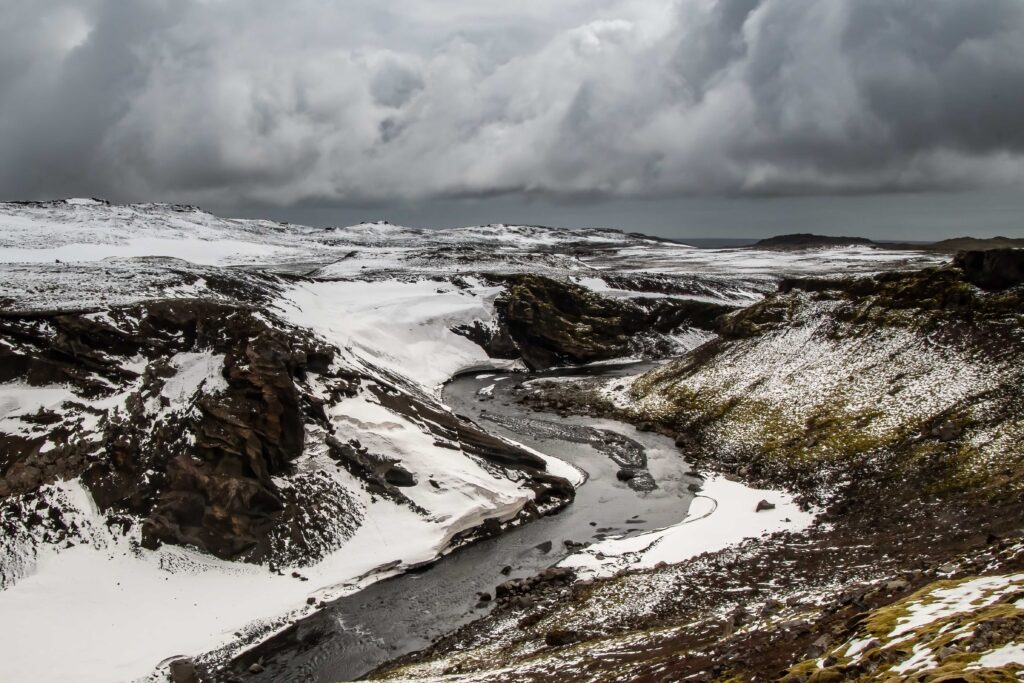 The Fimmvorduhals mountains covered in snow under a cloudy sky