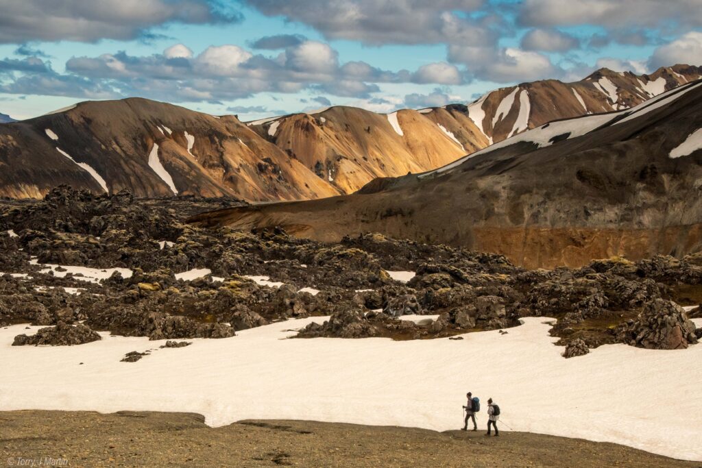 Two hikers trekking through Landmannalaugar, Iceland