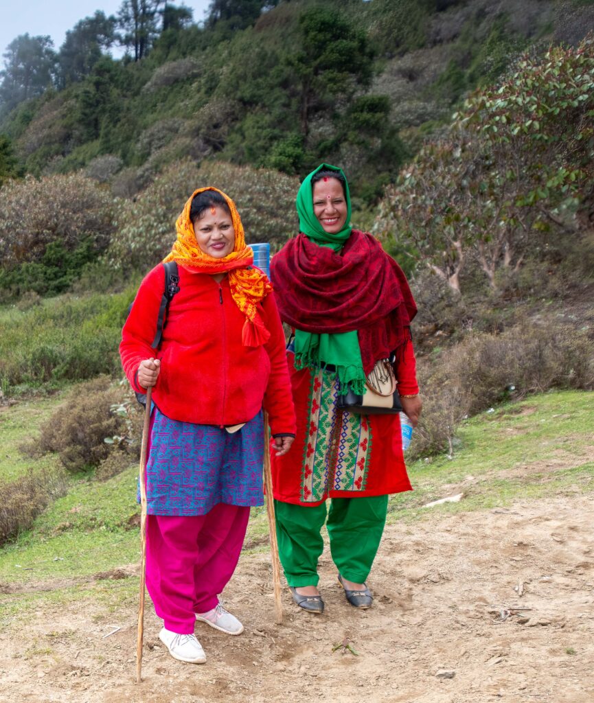 Two pilgrims adorned in colorful textiles on the Gosainkund Trek