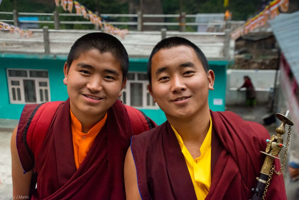 Two Buddhist Novtiates smiling for the camera