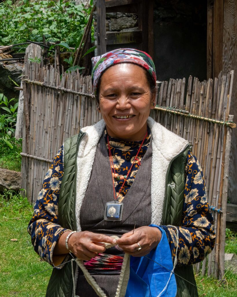 A portrait of a smiling teahouse entrepreneur in Langtang Valley